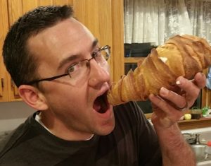 Man eating a lobster tail pastry