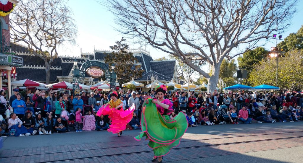 A crowd watches a parade at Disneyland