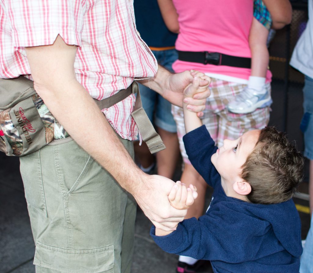 A little boy beseeching his Dad