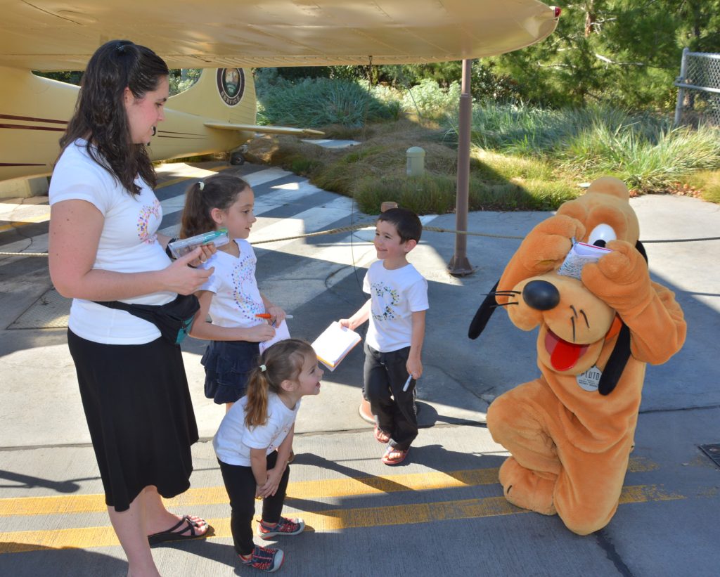 A group of guests meeting Pluto